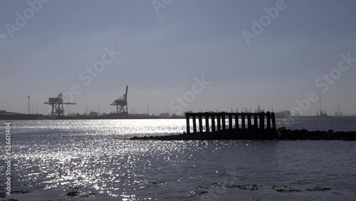 Teesside industry near Newcastle view from Redcar across water in morning light. Industrial landscape in the North of England by water UK 4K photo