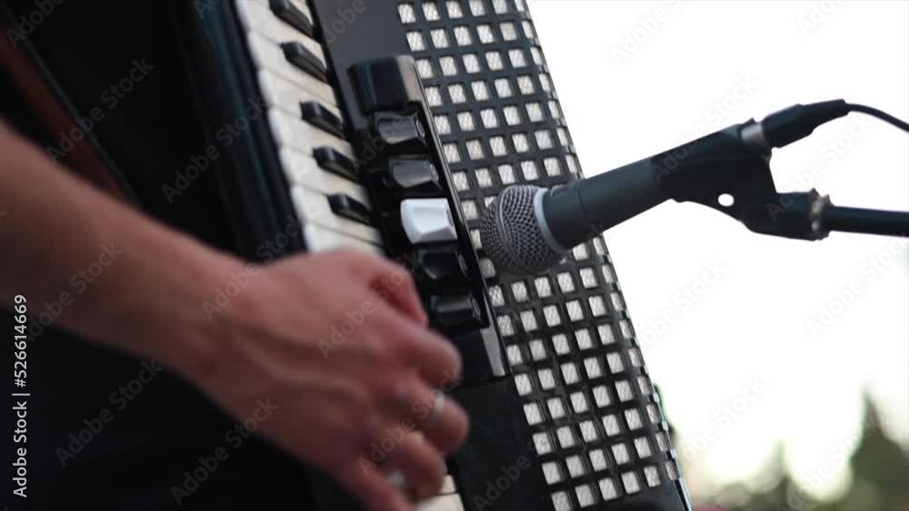 musician hand playing accordion keyboard at recital with microphone musician hand playing accordion keyboard at recital with microphone