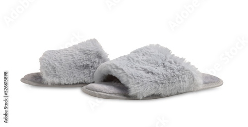 Pair of soft fluffy slippers on white background