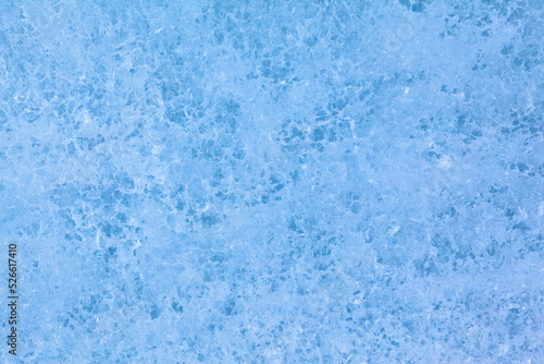 Texture of winter ice surface. Blue natural ice background