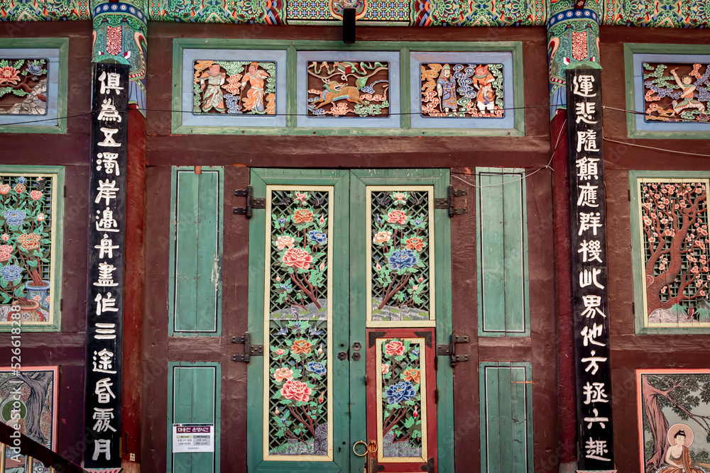 Colorful traditional Korean design painted wood artwork wall at Jogyesa