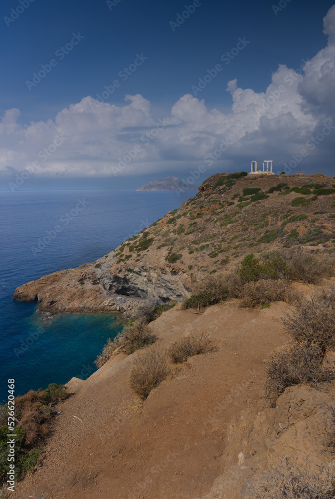Temple of Poseidon at Sounio Greece with dark clouds approaching the temple in the distance