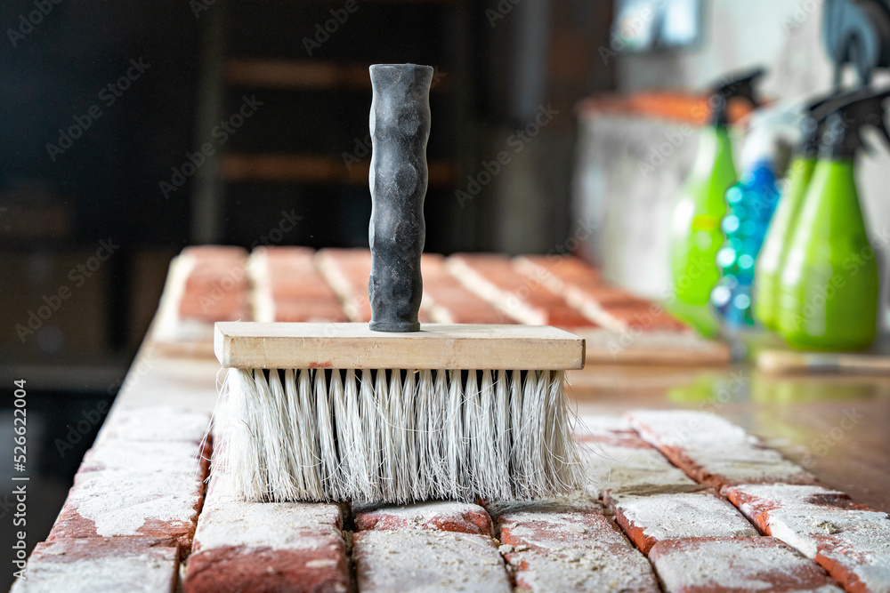 Row of bricks drying on craft table in white dust, whitewash. Aging process of casts from old