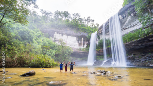 Waterfall in the deep forest. Huai Luang waterfall Huai Luang waterfall middle of the humid forest at Ubon Ratchathani, Thailand, Asia. Leaf moving low-speed shutter blur.