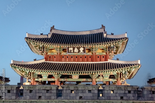 Colorful wooden traditional Korean architecture style Pungnammun Gate in Jeonju South Korea at dusk blue hour photo