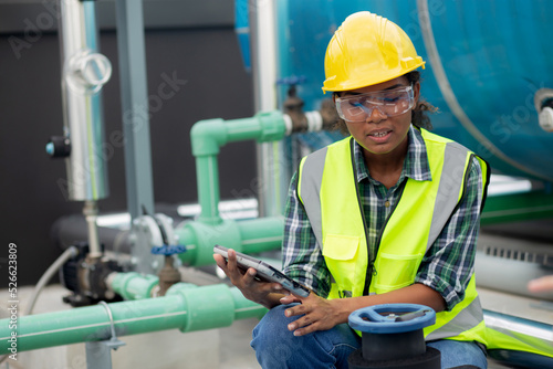 Young woman engineer examining pipeline and looking digital tablet with professional in the factory, mechanic or technician inspector plumber valve, one person, industrial and maintenance concept.