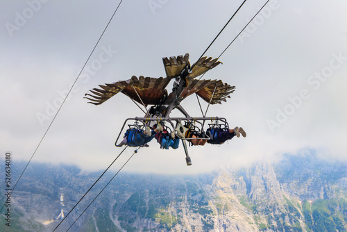 Grindelwald First peak activity - First Glider, Switzerland. Flying with a bird of prey, tourist attraction photo