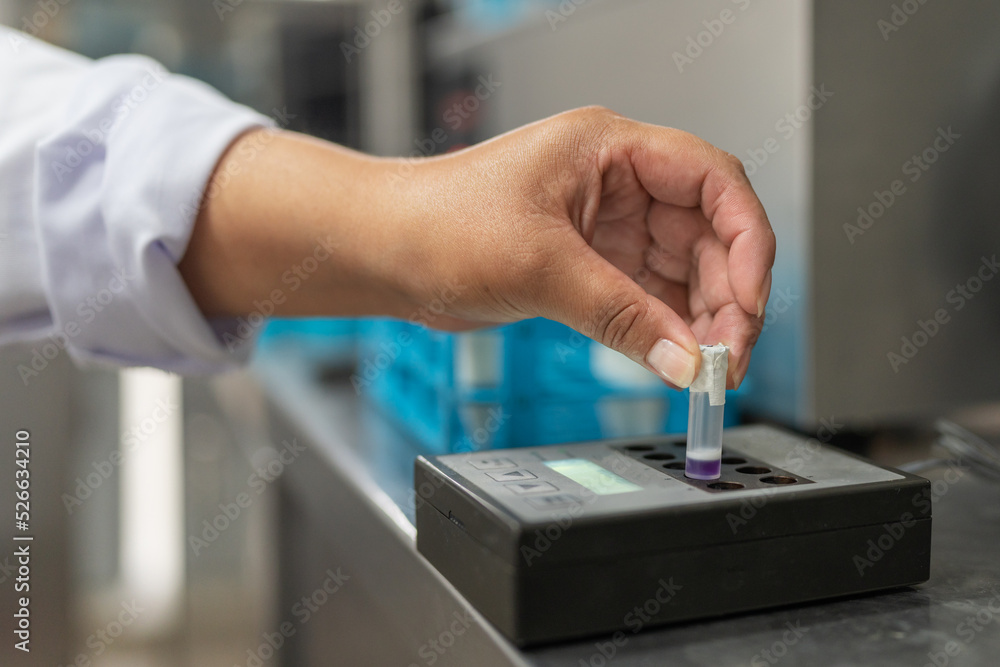 Hand of a woman working with samples in a laboratory of a dairy factory Hand of a woman working with samples in a laboratory of a dairy factory