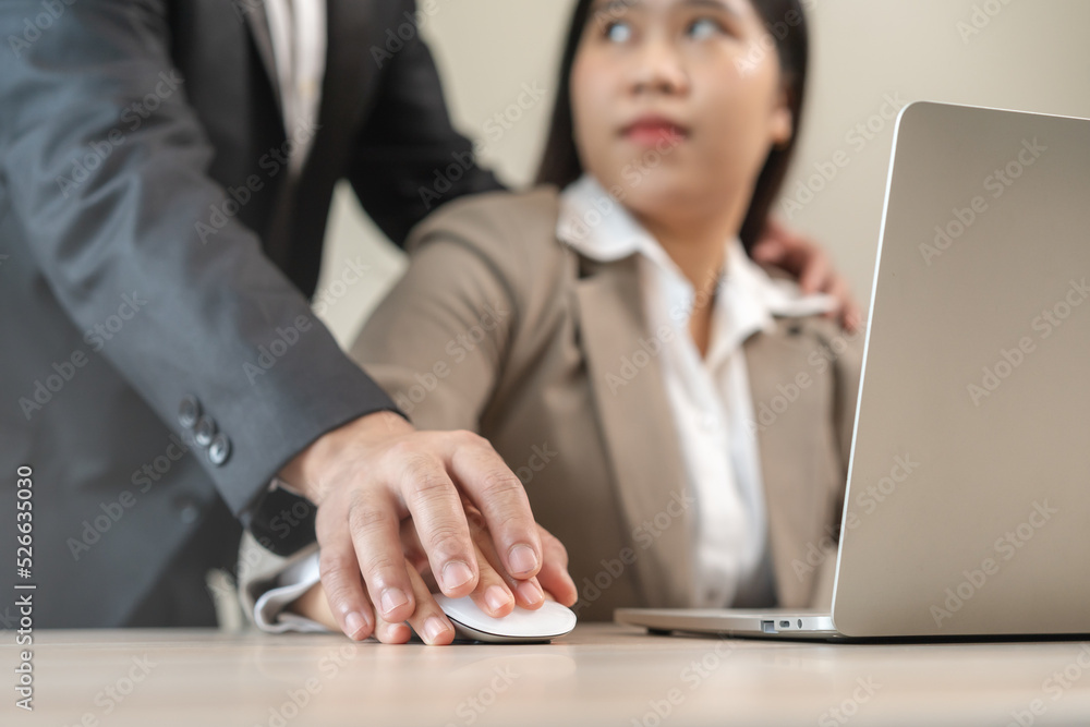 Unhappy, hand of asian young woman employee, man employer or colleague or boss touching her hand and embrace, feeling disgusted, uncomfortable. Sexual harassment inappropriate at workplace. Unhappy, hand of asian young woman employee, man employer or colleague or boss touching her hand and embrace, feeling disgusted, uncomfortable. Sexual harassment inappropriate at workplace.