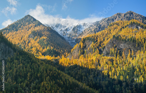 Autumn mountain view, snow-capped peaks, morning light © Valerii