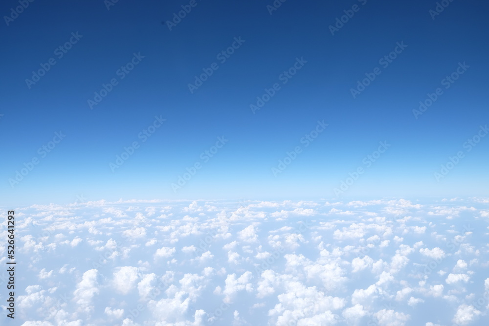 The sky is blue and fluffy clouds background