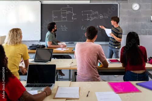 Εκτύπωση καμβά Teen male high school student giving oral class presentation in front of multiracial classmates