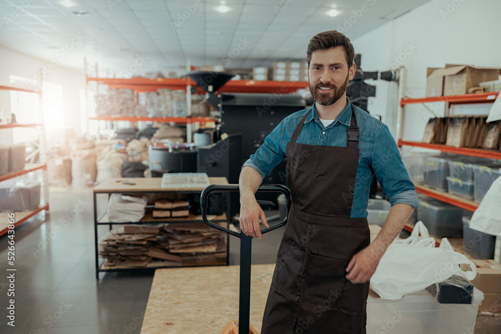 Business owner using forklift for loading bags of roasted coffee beans on warehouse Business owner using forklift for loading bags of roasted coffee beans on warehouse