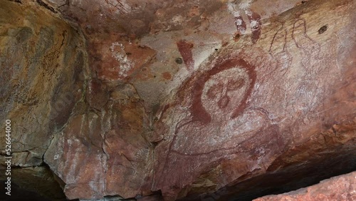 Wandjina dreamtime images a cloud and rain spirits from Australian Aboriginal mythology painted on rock galleries in a cave in Kimberley Western Australia.  photo