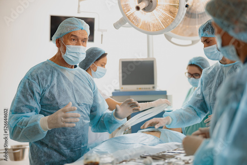 Concentrated surgical team working with a patient in an operation room in clinic