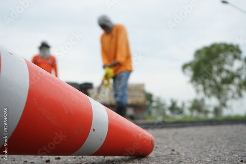 Blurred image of pavement repair work.