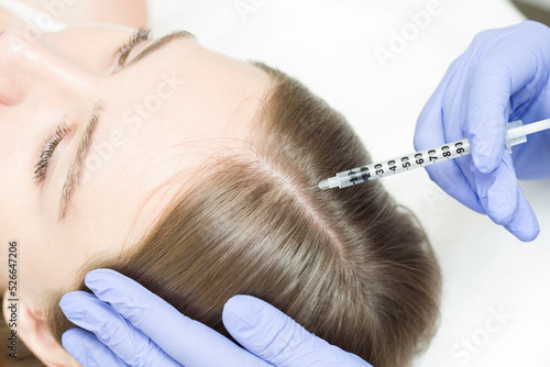 A woman receiving an injection into the scalp at a beauty center.