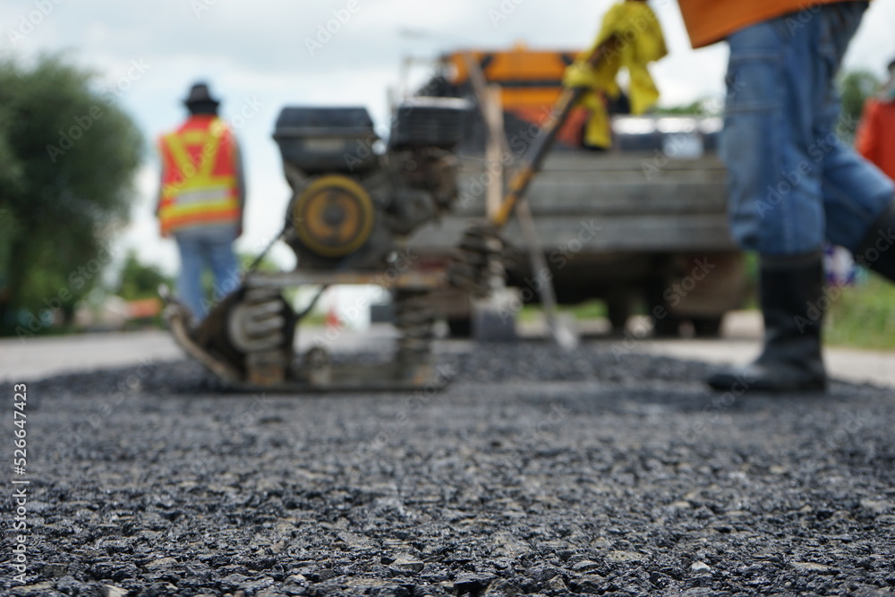 Blurred image of pavement repair work. Blurred image of pavement repair work.