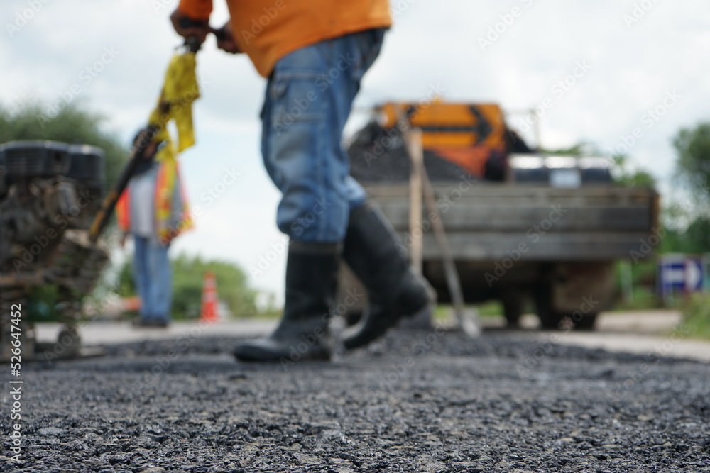 Blurred image of pavement repair work. Blurred image of pavement repair work.