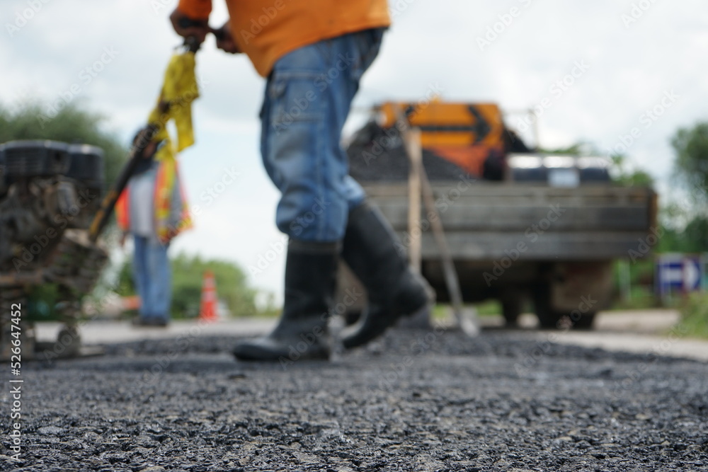 Blurred image of pavement repair work.