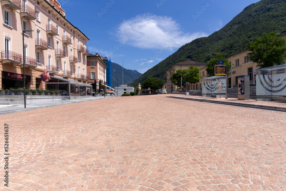 Main road made of red paving stones at City of Bellinzona, Canton Ticino, on a sunny summer day. Photo taken July 4th, 2022, Bellinzona, Switzerland.