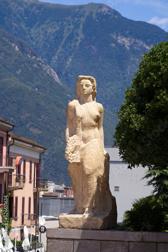 Stone sculpture of a woman at railway station Bellinzona  Canton Ticino  on a sunny summer day. Photo taken July 4th  2022  Bellinzona  Switzerland.