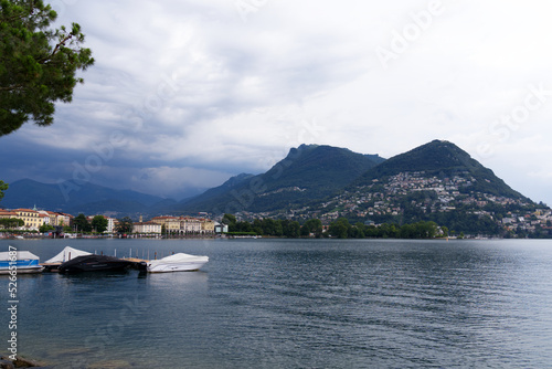 Scenic view of bay of Lake Lugano, Canton Ticino, on a cloudy summer day. Photo taken July 4th, 2022, Lugano, Switzerland. © Michael Derrer Fuchs
