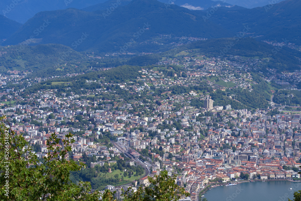 Aerial view of City of Lugano seen from local mountain San Salvatore on a sunny summer day. Photo taken July 4th, 2022, Lugano, Switzerland.