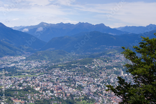 Aerial scenic view over region of Lugano, Canton Ticino, on a cloudy summer day. Photo taken July 4th, 2022, Lugano, Switzerland.