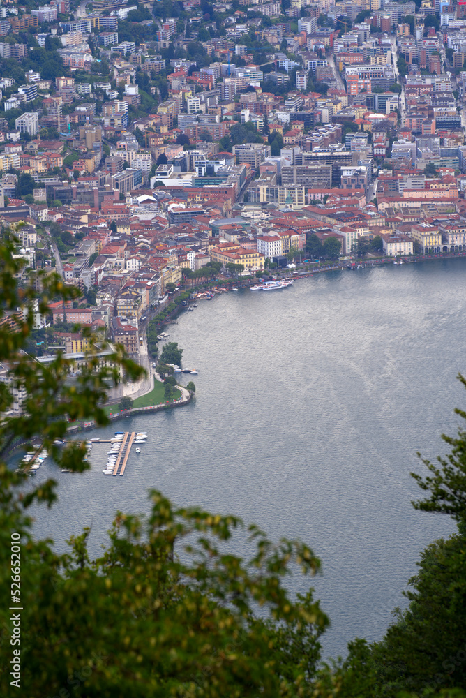 Fototapeta premium erial view of City of Lugano seen from local mountain San Salvatore on a sunny summer day. Photo taken July 4th, 2022, Lugano, Switzerland.