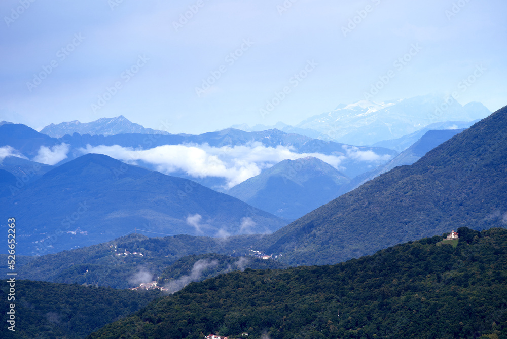 Naklejka premium Aerial scenic view over region of Lugano, Canton Ticino, on a cloudy summer day. Photo taken July 4th, 2022, Lugano, Switzerland.