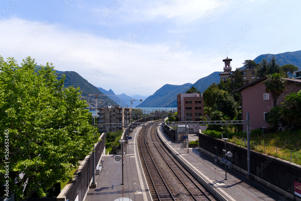 Aerial view of railway station Lugano Paradiso on a blue cloudy summer day. Photo taken July 4th, 2022, Lugano, Switzerland.