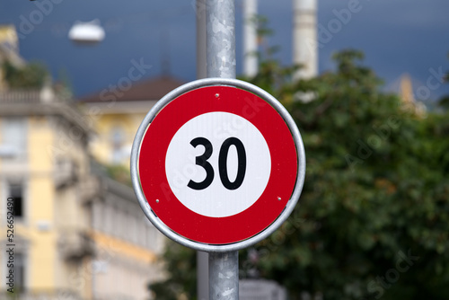 Traffic sign speed limit 30 kilometers per hour at City of Lugano on a cloudy summer day. Photo taken July 4th, 2022, Lugano, Switzerland. photo