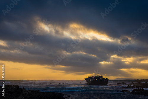 The sun sets beneath a dramatic sky at the wreck of the Meisho Maru No. 38 on the beautiful Cape Agulhas coastline near the seaside town of L'Agulhas in the Overberg, Western Cape. South Africa. © Roger de la Harpe