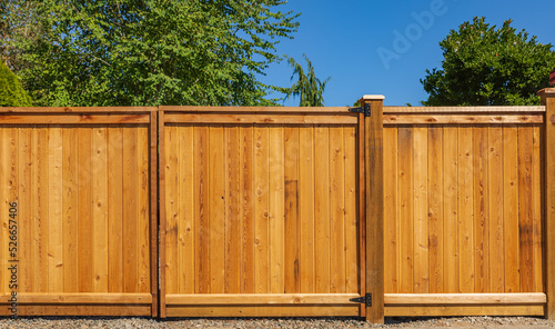 Nice new wooden fence around house. Wooden brown fence. Street photo, nobody photo