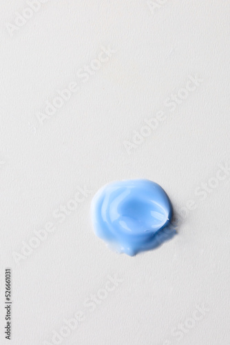 Blue cream texture   cosmetic smear  lotion swatch on beige background. Skin care product design