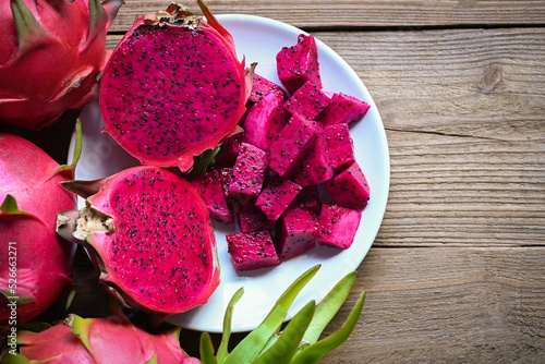 dragon fruit slice and cut half on white plate with pitahaya background, fresh pink red purple dragon fruit tropical in the asian thailand healthy fruit concept