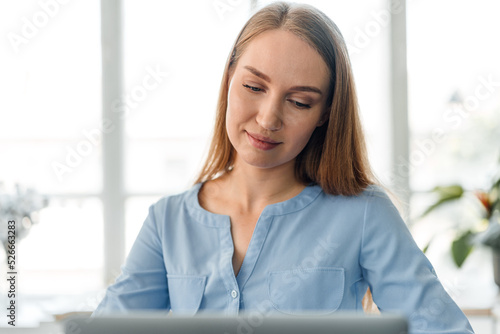 Young female entrepreneur working on a laptop at home Free Download Young female entrepreneur working on a laptop at home - GFXLoad