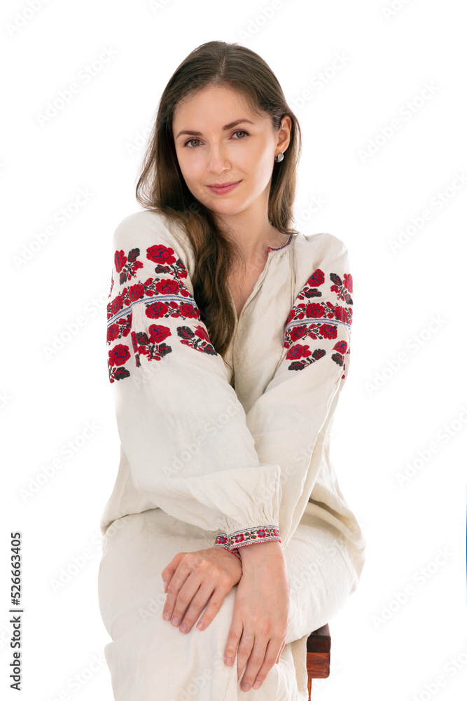 Portrait of a young girl in traditional Ukrainian clothing isolated on white background. Horizontal portrait of pleasant-looking Caucasian female with long hair and smiling in camera. Portrait of a young girl in traditional Ukrainian clothing isolated on white background. Horizontal portrait of pleasant-looking Caucasian female with long hair and smiling in camera.