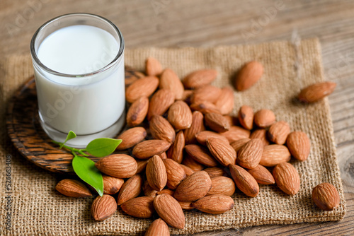 Almond milk and Almonds nuts on on sack background, Delicious sweet almonds on the table, roasted almond nut for healthy food and snack