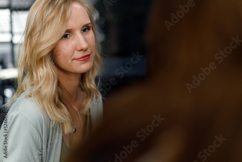 Blond woman looking and listening to manager in office