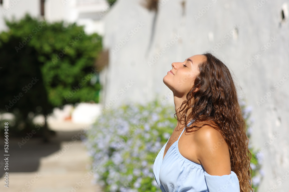 Woman breathing fresh air in a white town Woman breathing fresh air in a white town