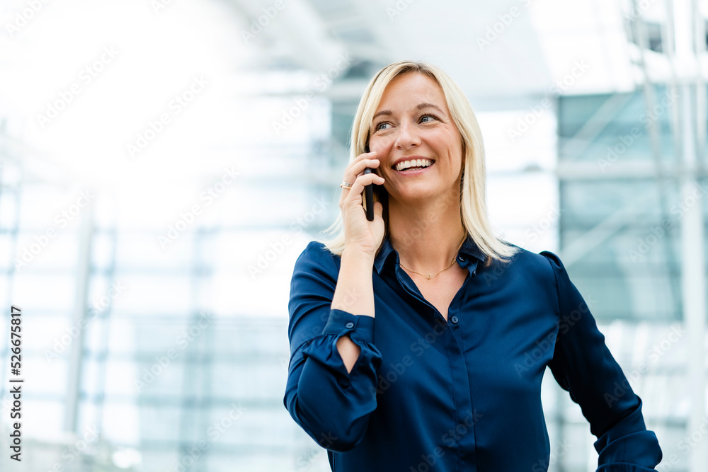 Smiling businesswoman talking on mobile phone Smiling businesswoman talking on mobile phone