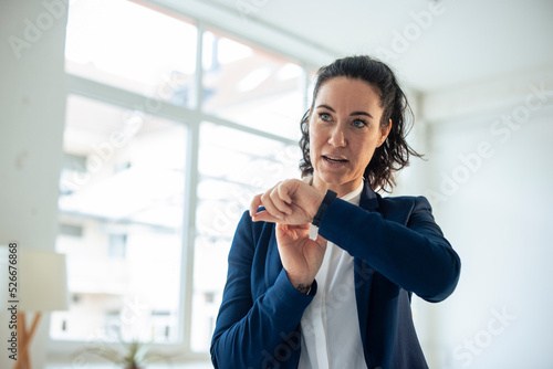 Businesswoman sending voicemail through smart watch photo