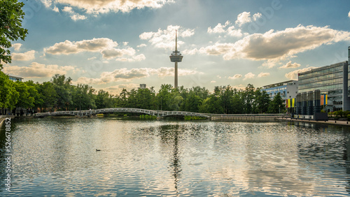 Germany, North Rhine-Westphalia, Cologne, MediaPark lake at dusk with Colonius tower in background photo