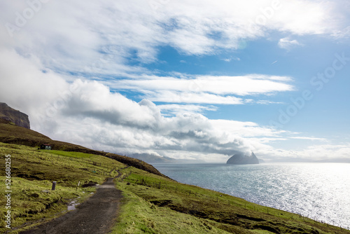 Faroe Islands, Vagar, Clouds over coastal dirt road with islands in background photo