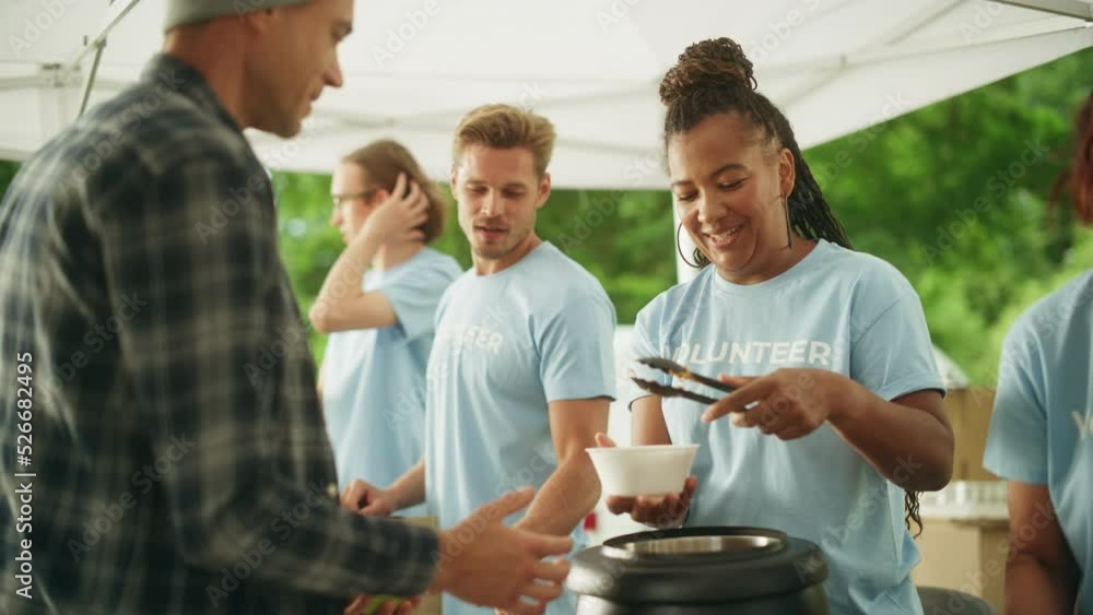 Humanitarian Aid Concept Volunteers Preparing Free Food and Feeding Local Community that is in