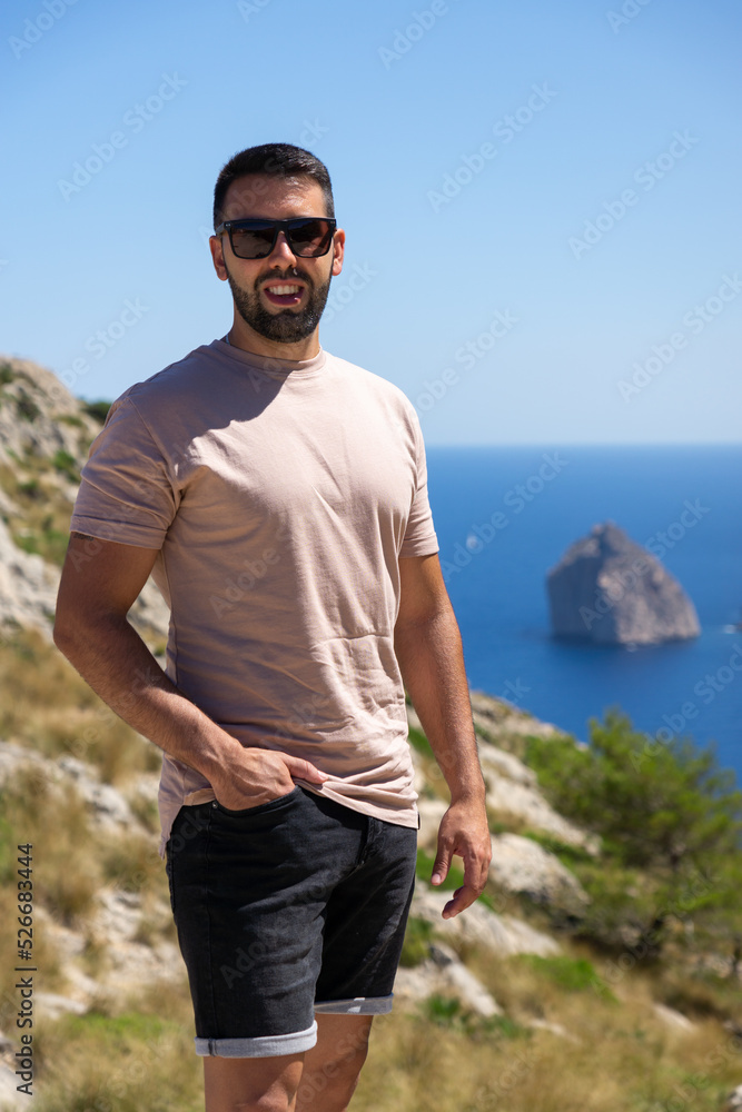 Young man visiting the viewpoint es Colomer in Mallorca, Spain. Young man visiting the viewpoint es Colomer in Mallorca, Spain.