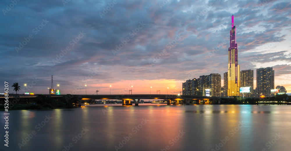 Panorama landscape photo: View of buildings located on the Saigon River.Time: August 19, 2022. Location: Viet Nam. Content: the beauty of buildings at sunset in Ho Chi Minh City.