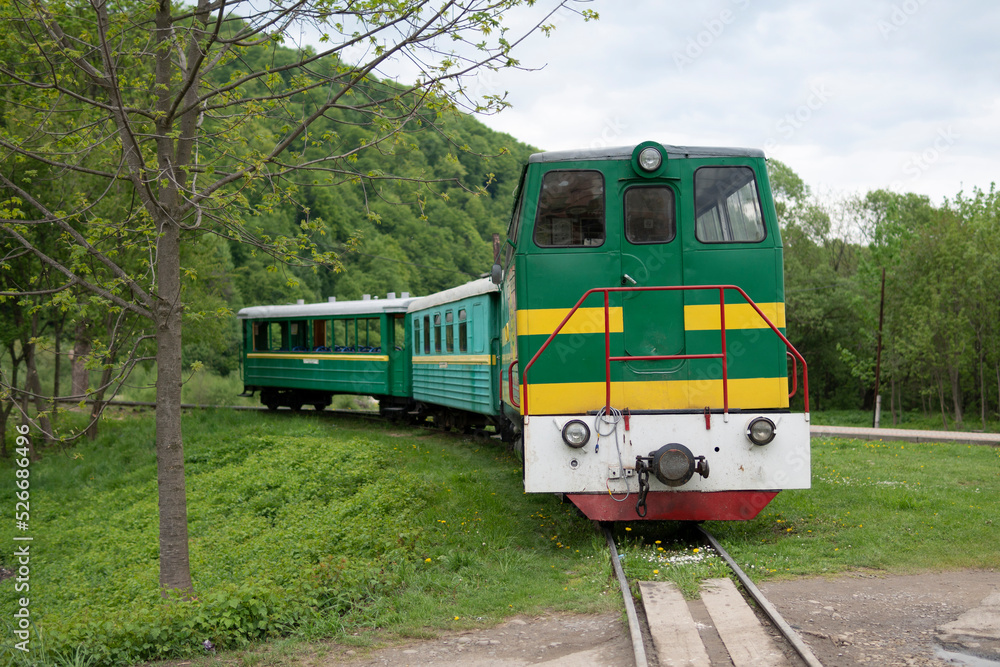 Old narrow-gauge tourist train in Ukrainian Carpathian mountains